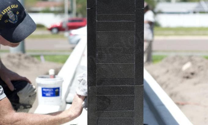 Norstone Ebony Basalt Lynia Interlocking Natural Stone Tiles on a large monument wall featuring the outside corner detail